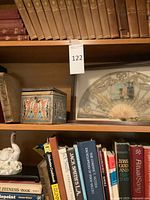 Books on shelving with decorative items visible