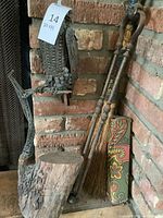 Overall view showing bird sculpture, broom, tongs, matchbox