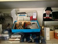 Shelf view showing wreath, blue tray of games, flashlights, plush figure, additional décor items