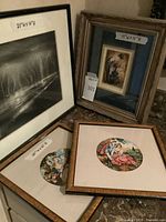 Group shot of four framed artworks showing fronts and relative sizes
