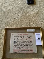 Full view of framed sheet music with lot tag