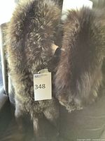 Two brown fur stoles hanging