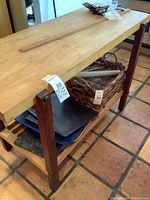 Full view of wooden kitchen work table island with butcher-block top and lower shelf