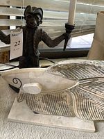 Monkey lamp and fish sculpture side by side