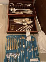 Overview of all utensils in wooden case drawers and flatware roll