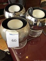 Three chrome and acrylic table spotlights grouped together