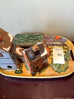 Top view of tray with ceramic houses and metal box