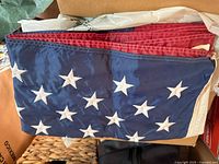 Folded section of US flag with embroidered stars and stripes
