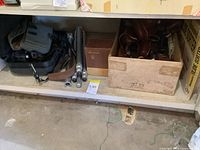 Shelf with camera bags, tripod parts, boxes