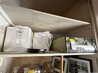 Shelf with Waterford decanter, lazy Susan base, boxed salad set