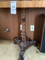 Entire table base showing turned pedestal and scrolled supports