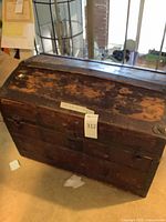 Exterior of wooden dome-top trunk with metal hardware