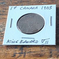 Coin in 2x2 cardboard holder showing date and annotation