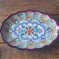 Front view showing full painted design and scalloped rim