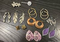 Overview of all earrings and hair pins laid on black surface