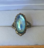 Top view showing oval blue cabochon and bezel detail