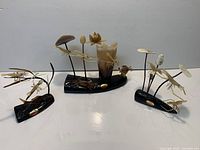 Full view of all three sculptures on white background