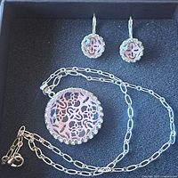 Necklace and earrings laid out in gift box showing design details
