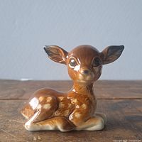 Front view of glazed porcelain fawn figurine