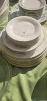 Stacked small plates with floral patterns and gold rims