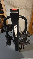 Full front view of Yakima bike rack showing logo, wheel holders, and straps.