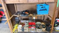 Wide view of shelf showing various tools, hardware boxes, rope, and hardware containers on wooden shelves.