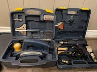Mastercraft planer and heat tool displayed in their respective carrying cases, showing the tools and several nozzle attachments for the heat tool.