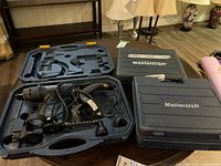 Mastercraft Spin Saw and two Mastercraft cases placed on a table with lamps in background.
