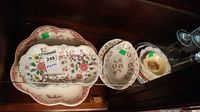 Floral serving plates and bowls arranged showing scale and pattern