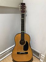Full frontal view of the Degas acoustic guitar showing body, neck, and strings.