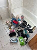 Full overview of all items showing an assortment of electric razors, hair dryer, boxed soaps, humidifier, and accessories on a bathroom floor