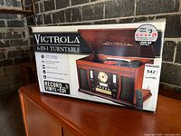 Original boxed Victrola 6-in-1 turntable showing front and side of packaging with product image and branding
