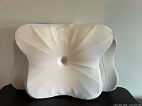 Front view showing contoured white side and central depression