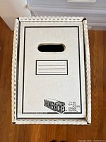 Front view showing DrawerBoxes branding, hand hole and label lines