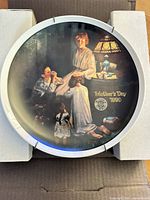 Front view of the Norman Rockwell Mother’s Day 1990 collector plate in shipping box