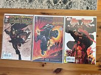 Front view of all three bagged comics on table