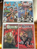 Four bagged single-issue DC comics: two The Question, two Arak: Son of Thunder, arranged flat
