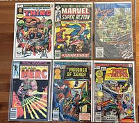 All six bagged and boarded comics laid out—The Thing Annual, Marvel Super Action, Marvel Age, Merc, Prisoner of Zenda, Prince and the Pauper
