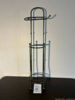 full front view of silver metal toilet paper stand