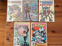 All five bagged and boarded comics laid out; three Outcasts issues on top row, two Plasmer issues bottom row.