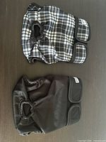 Top view of both diapers folded showing outer fabric, tail holes and hook-and-loop closures