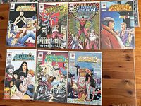 Seven Archer & Armstrong comic books laid out