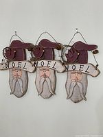 Three matching Santa wall hangings front view