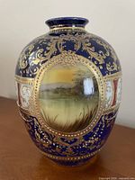 Front view showing swan landscape panel and gold gilt details