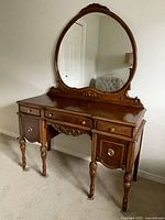 Full view of vanity with attached oval mirror