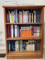 Full view of three shelves filled with books