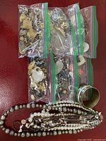Overview of bagged loose pieces, necklaces and cuff bracelet