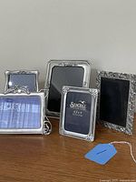 All five Seagull pewter frames viewed together on tabletop