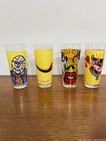 Front view of four pop-art Ritzenhoff milk glasses