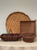 Group view of four woven baskets showing size and variety